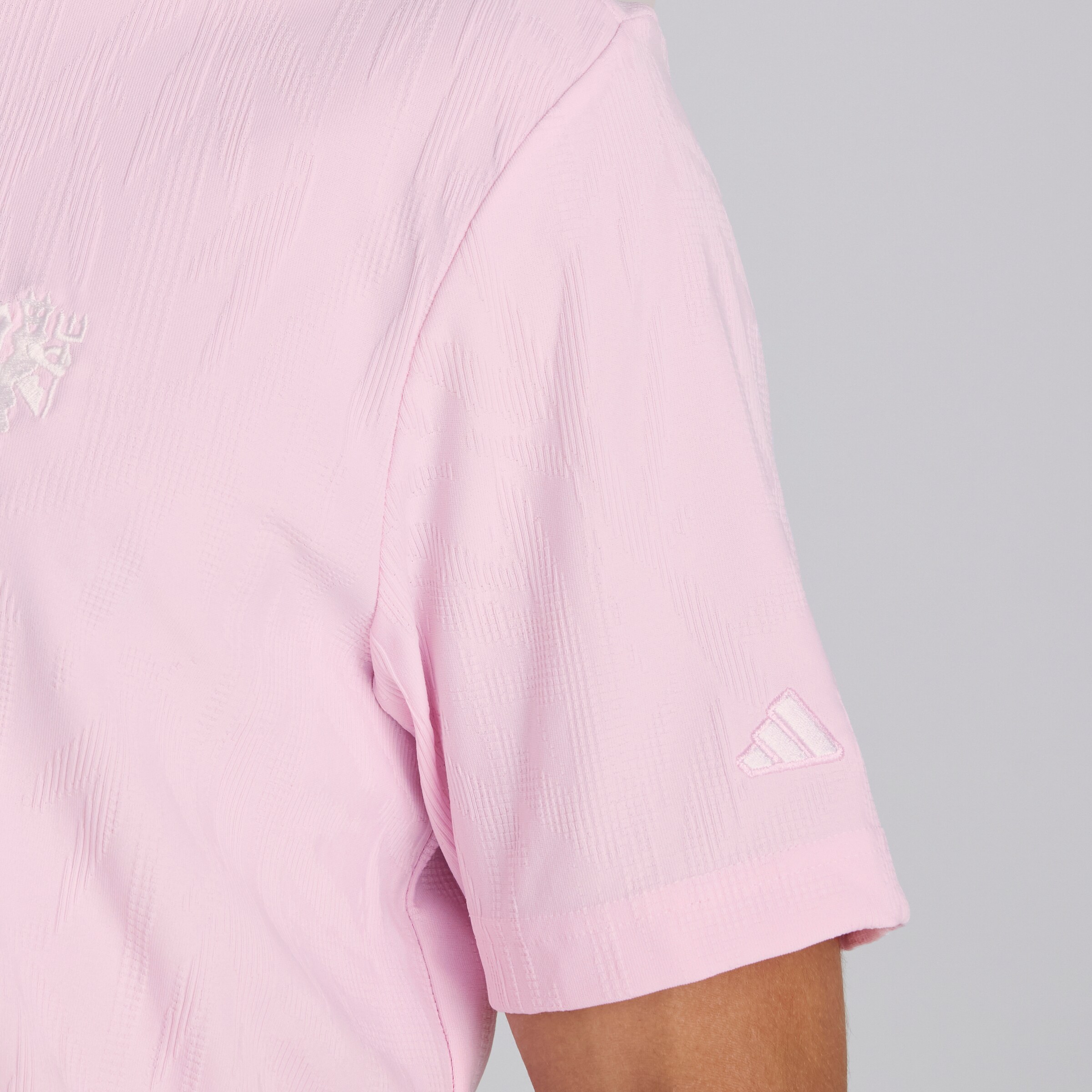 Manchester United x adidas Golf Go-To Textured Polo Shirt Pink Pink Detail [4-5]